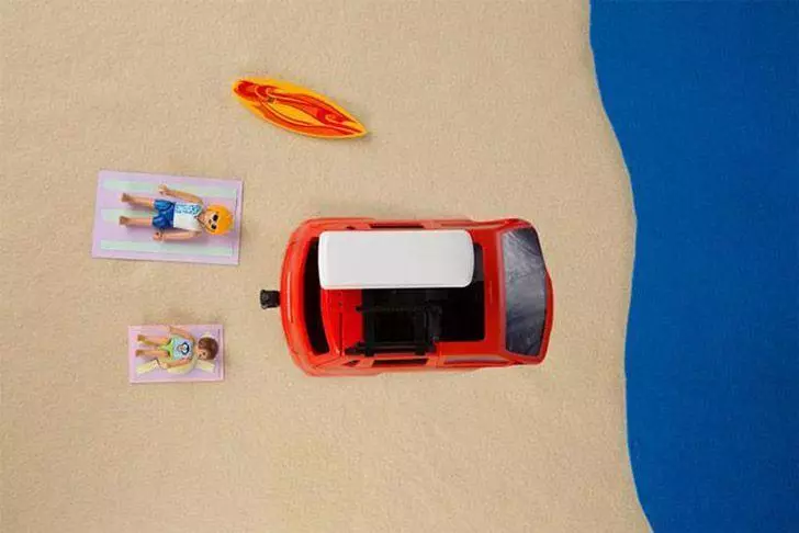Car sinking in the sand after being parked on the beach