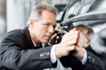 Customer inspecting rental car