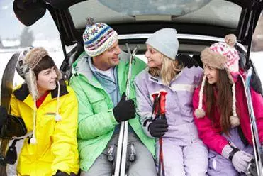 Family with rental car on ski holiday