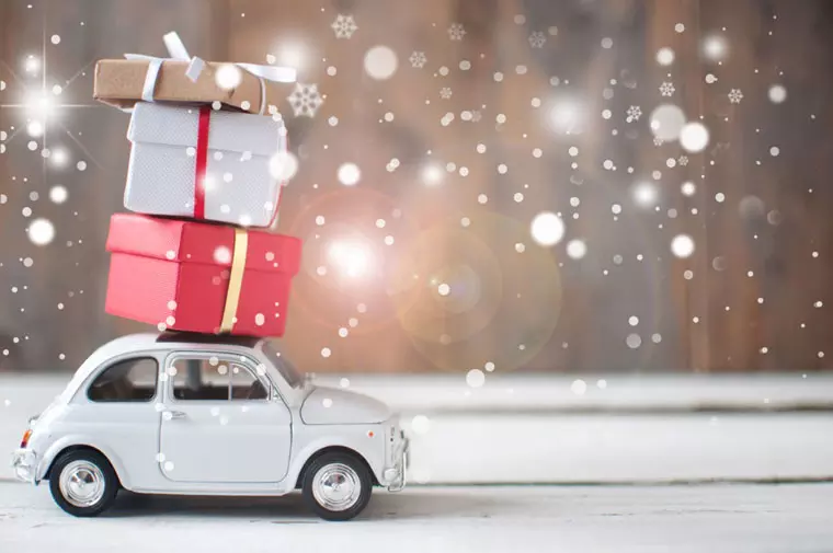 Gift boxes stacked on top of a toy car