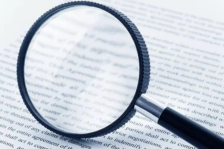 magnifying glass and paperwork