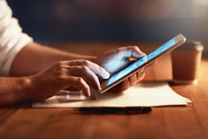 Man browsing the internet on his tablet