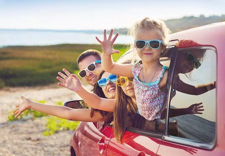 Family waving in the summer