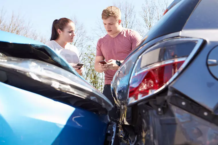 Two drivers exchanging information after accident