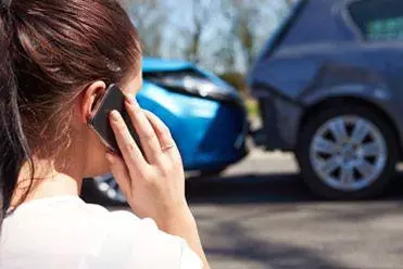 Female driver reporting an accident involving her hire car